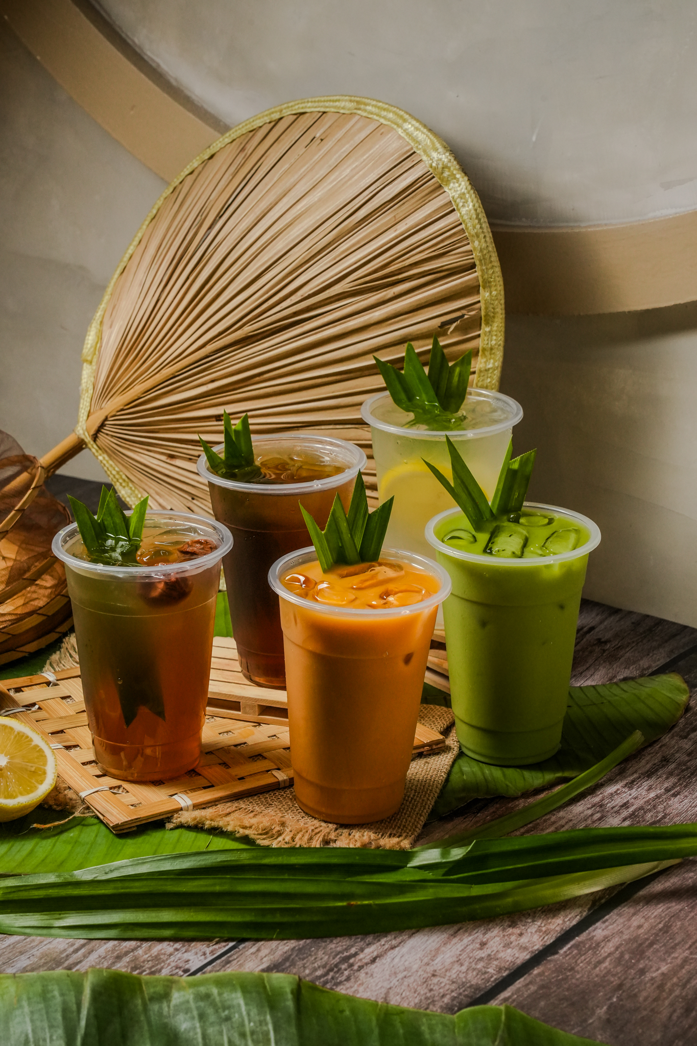 Thai drinks and refreshments with fan and banana leaf